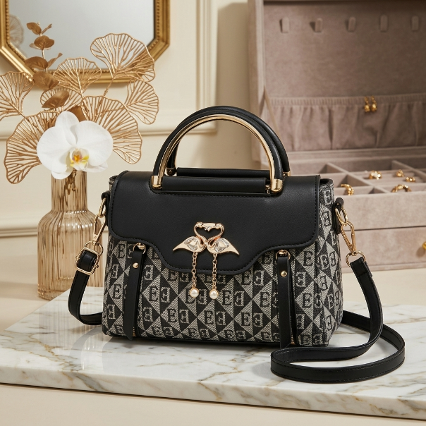Black and patterned handbag with gold accents on a marble surface, with a jewelry box and decorative elements in the background.