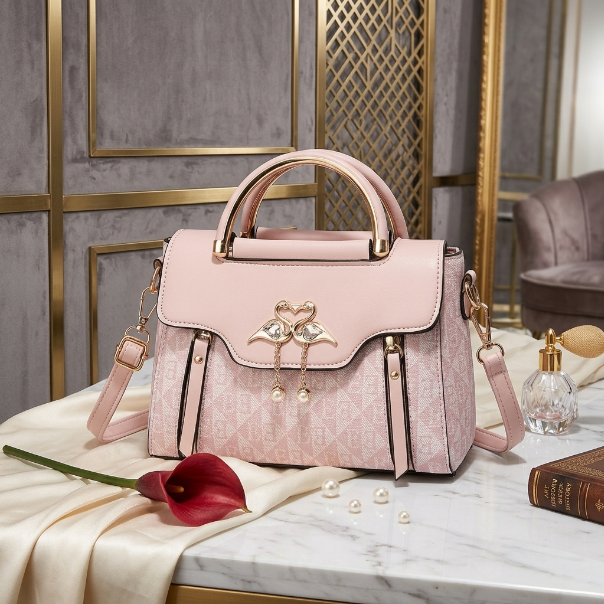 Pink handbag with decorative elements on a marble surface with a stylish background
