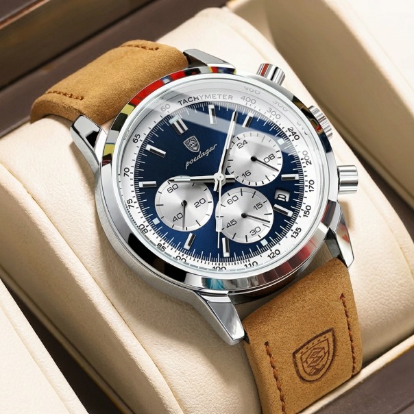 Luxury watch with brown leather strap and blue dial on beige cushion