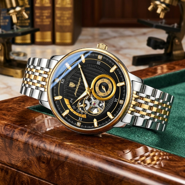Luxury watch with gold and silver band on a wooden surface