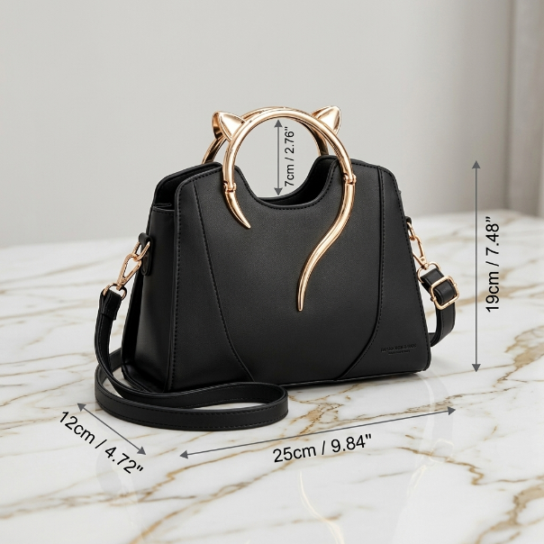 Black handbag with gold accents on a marble surface, showing measurements.