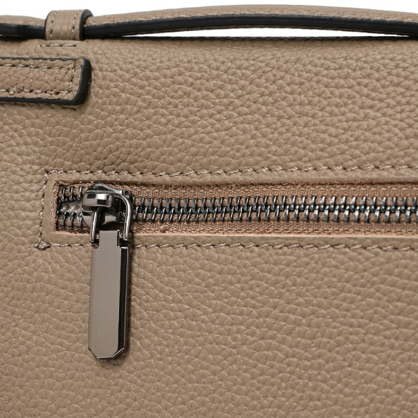 Close-up of a beige leather handbag with a zipper