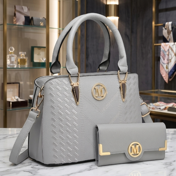 Khaki handbag with gold accents and matching wallet on a marble surface.