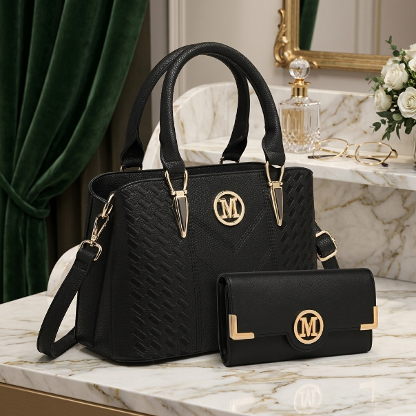Black handbag with gold accents on a marble surface