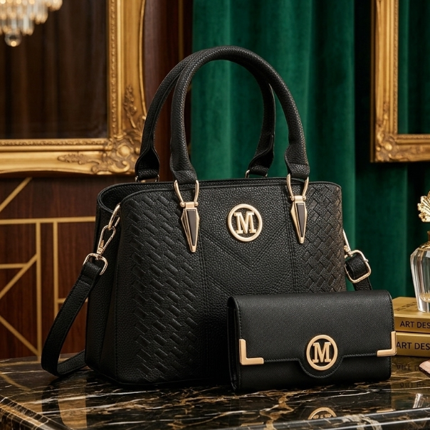 Black handbag with gold accents and a matching wallet on a marble surface with a decorative background.