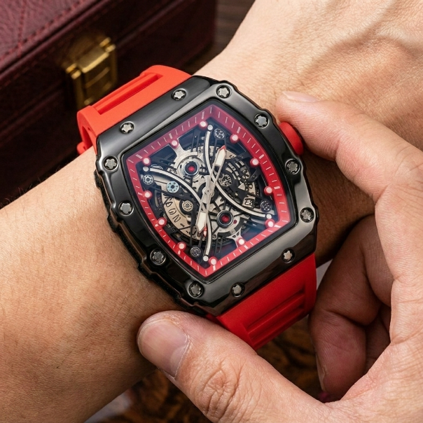Person wearing a red and black watch with a detailed face.