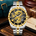 A luxury two-tone stainless steel and gold watch with a detailed dragon skeleton dial, displayed on a dark wooden surface with a leather strap and vintage book in the background.