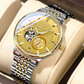 Luxury watch with gold and silver design on a beige cushion