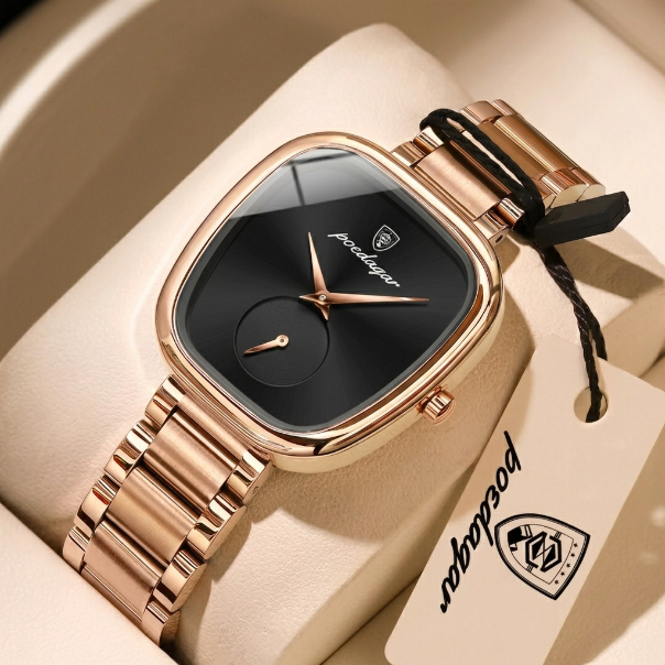 Rose gold watch with black face on a beige cushion, branded 'Pacoliner'.