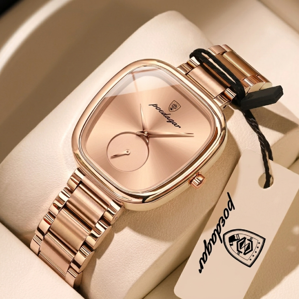 Rose gold watch with a brand tag on a beige background