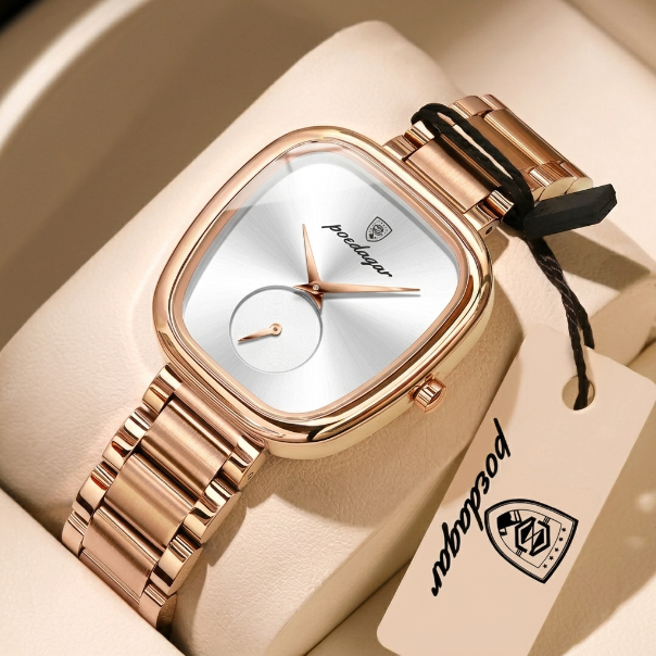 Rose gold watch with a tag on a beige background