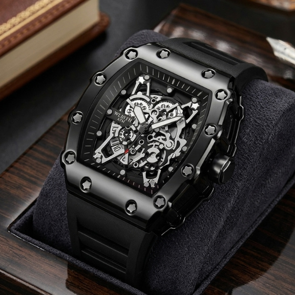 Black wristwatch with intricate design on a wooden surface
